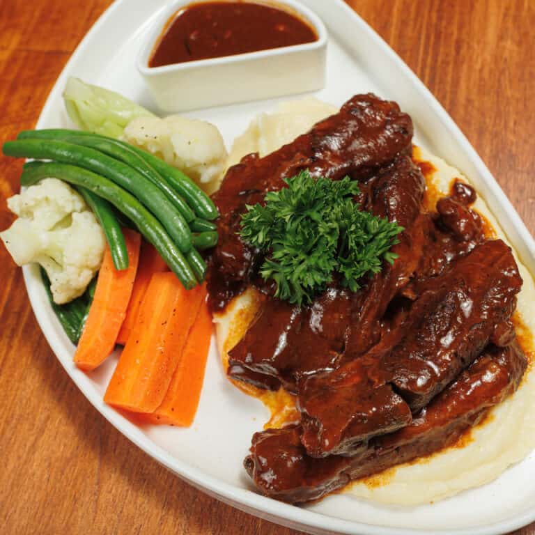 Marinated American pork ribs served with homemade BBQ sauce